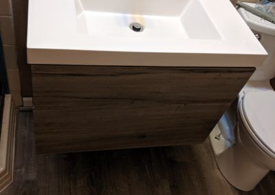 New vinyl floors and matching floating vanity with sink