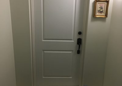 New 2-panel Shaker entry door at inside hallway of high-rise