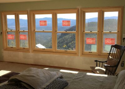 6 new windows and drywall with forested mountains outside