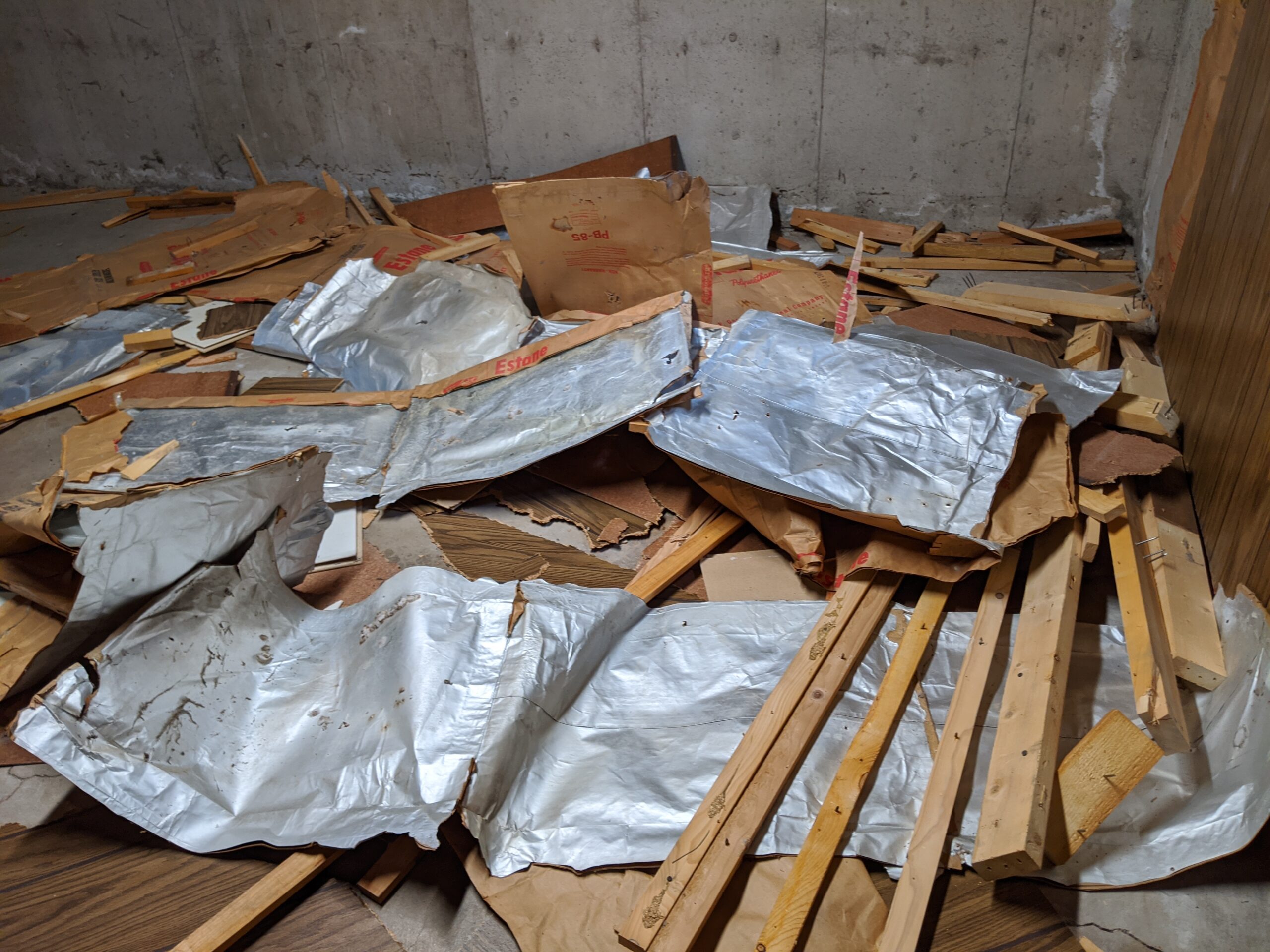 Big ole pile of trash -- paneling, moisture vapor barrier paper, and lumber from the basement walls!