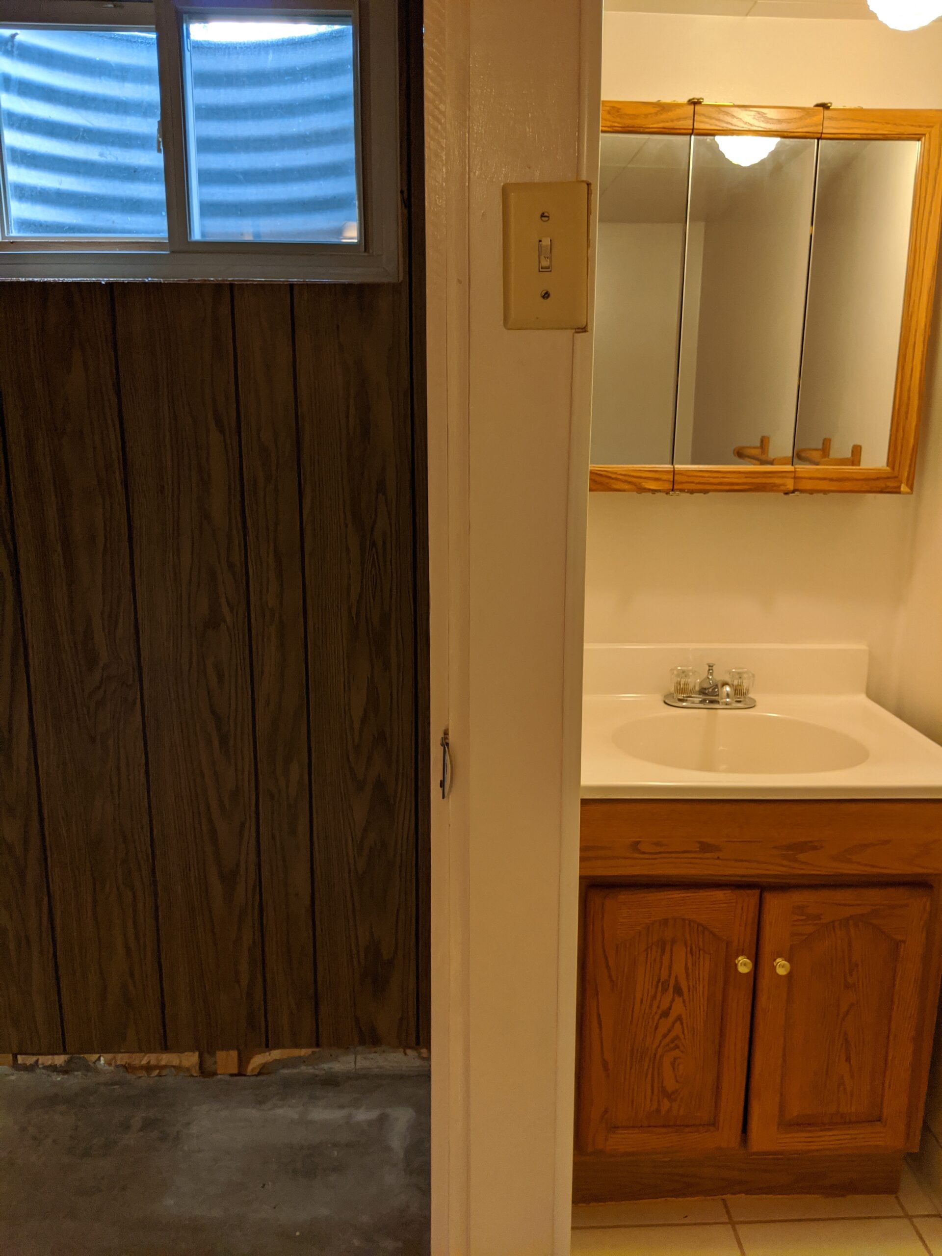 The home inspector identified a few code violations, like no exhaust fan or window inside the basement bathroom and this light switch being too high.