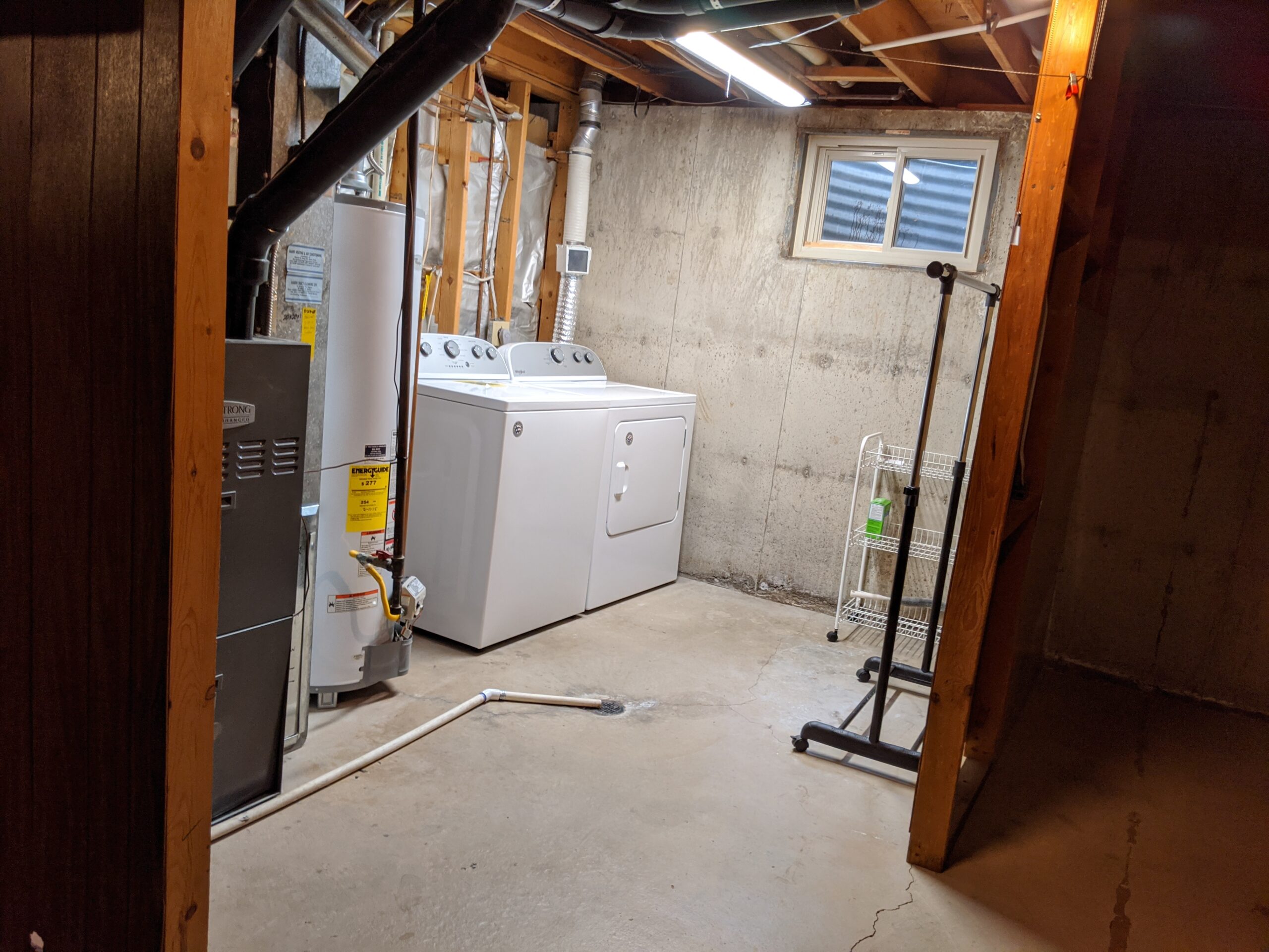 The 1-year-old clothes washing machine and dryer were originally next to the water heater and furnace in an open utility area, on the other side of the bathroom wall. We are making space for them in the bigger basement bathroom floor plan for convenience and cleanliness.