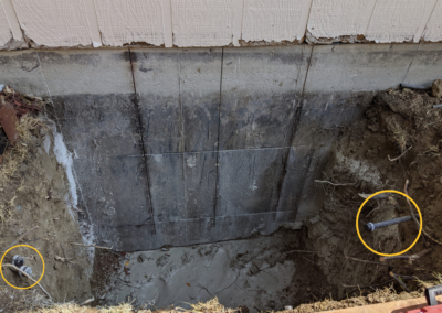 IN PROGRESS: Be sure to call before you dig! For safety’s sake, you must make sure not to cut any power, water, gas, or other utility lines when digging deeper window wells. You also may have to cut, cap, and relocate underground sprinkler pipes, like those circled in yellow in this picture.
