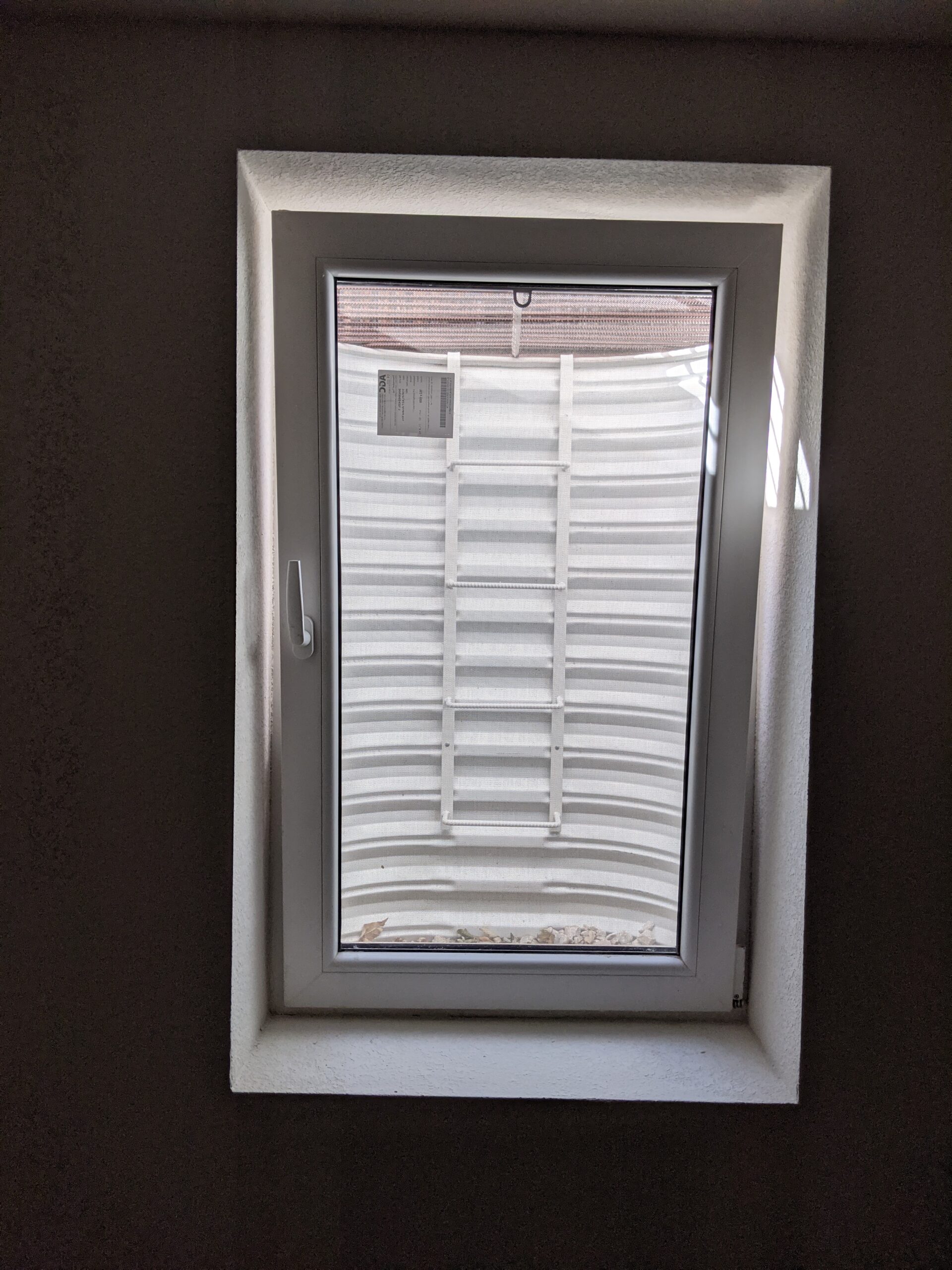 BONUS FEATURE: If you turn the handle all the way up, the top of the window tilts into the room while pins are still engaged to lock it into the frame and prevent it from being opened. You can see light coming in around the top two-thirds of this vented window. This top vent helps to increase circulation of fresh air in the basement and prevent musty smells while remaining securely closed.