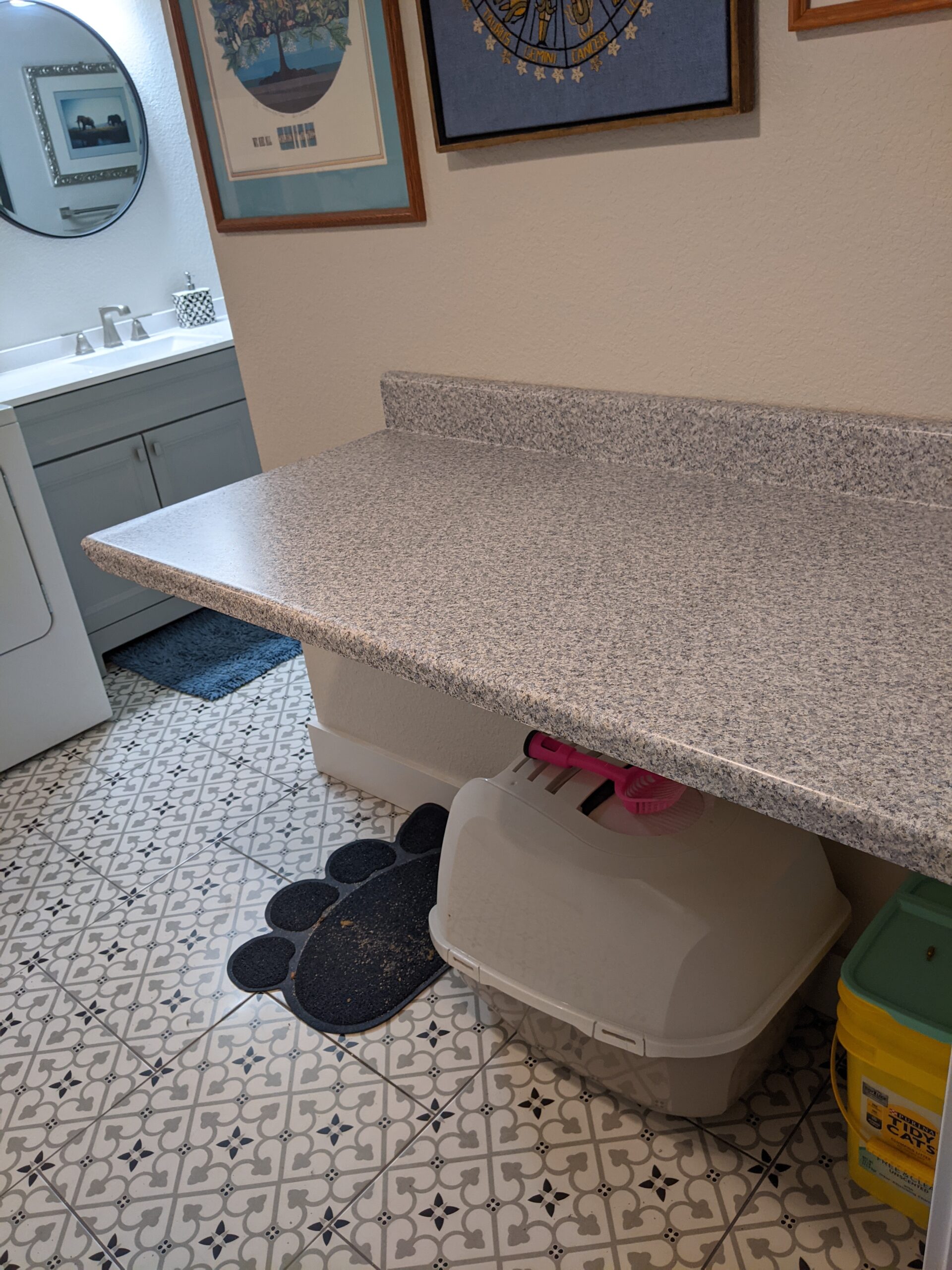 AFTER We covered and reused this countertop as a folding station in our basement’s combination bathroom/laundry room.