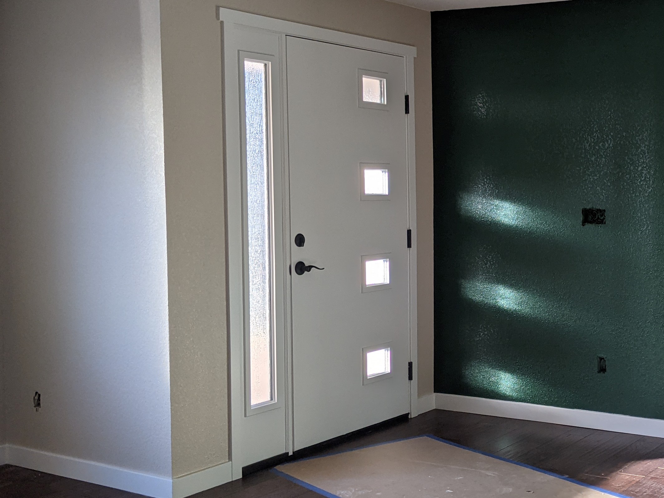 AFTER The windows in this front door let the light in while the obscured glass protects the homeowners' privacy.