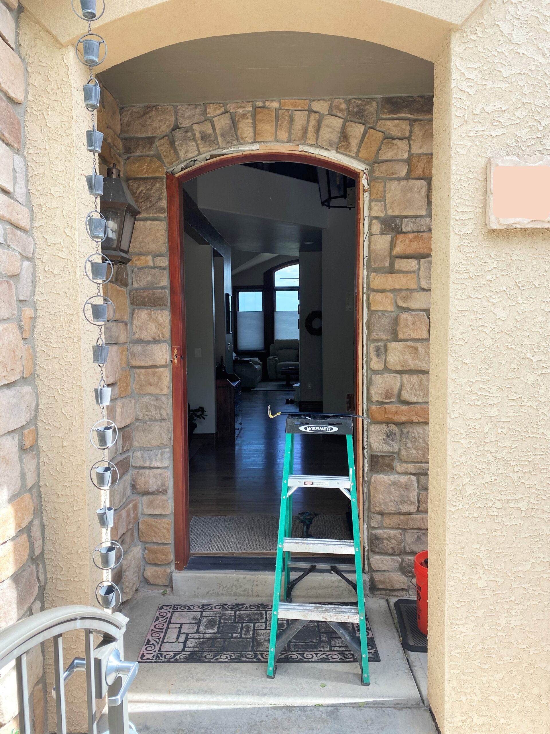 DURING Arched doorways require an exact fit, especially in a stone wall like this entry door.