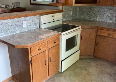 2. Out-of-date kitchen with ineffective use of space, outdated oak cabinets, and worn countertop.