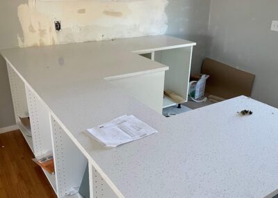 15. Custom peninsula and solid stone countertop installed in home kitchen renovation