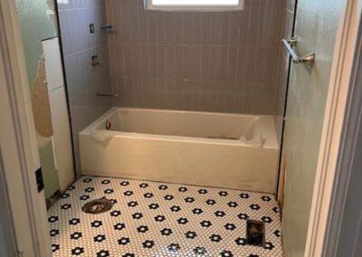 26. During home bathroom remodel, new tile floor, tile bath enclosure and tub installed.