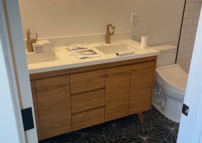 Stunning new modern vanity and flooring in basement bathroom remodel