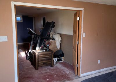 After removal of existing dated flooring, unfinished basement ready for new finishes.