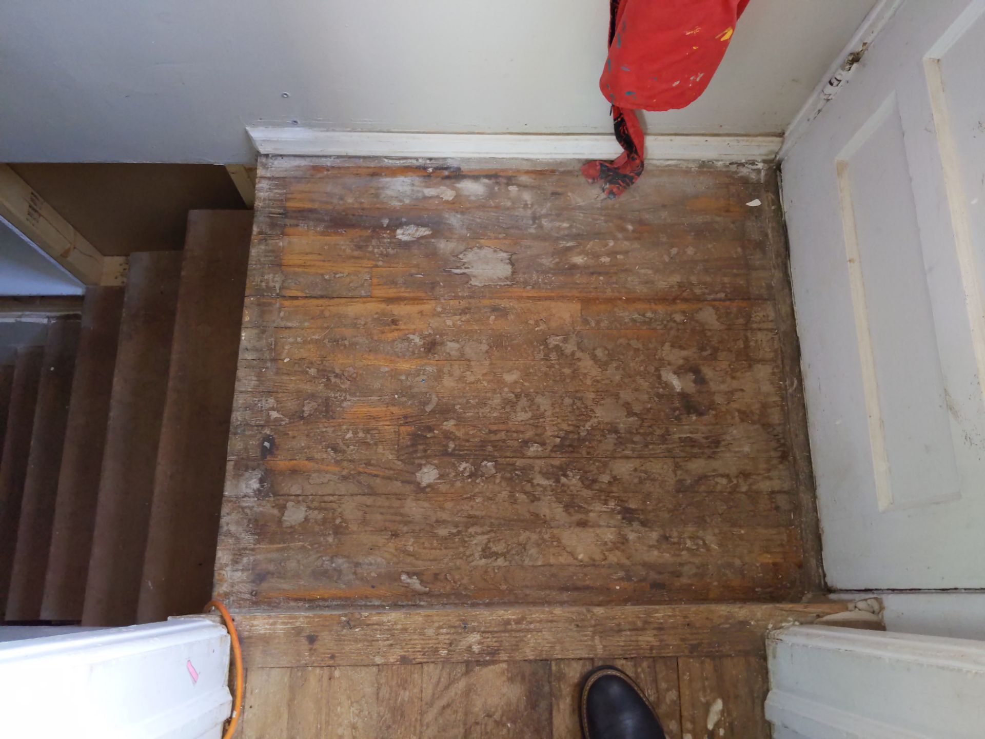 Detailed view of heavily worn original 80 year old wood floors before restoration in an old Denver home.
