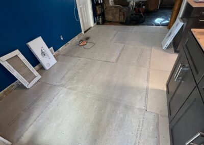 Tile backerboard installed in a kitchen, preparing for final flooring installation.