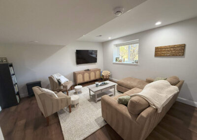 Basement seating area with sofa and armchairs