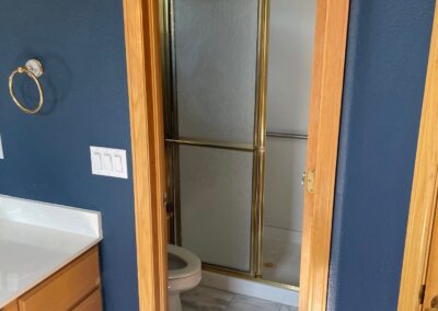BEFORE: The gold-framed shower stall didn't fit the homeowners' idea of luxury.